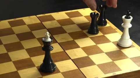 Guy black figures puts a linear mat two rooks to the white king and he falls on Stock Footage 142928179