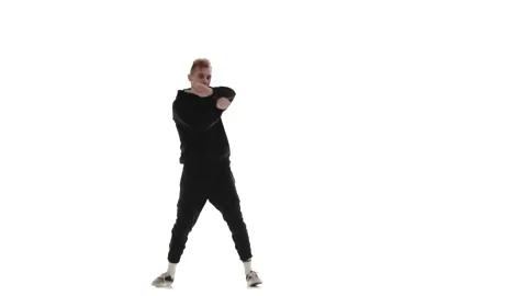 Guy in black tracksuit dancing hip hop, freestyle, street dance, isolated Stock Footage 130382613
