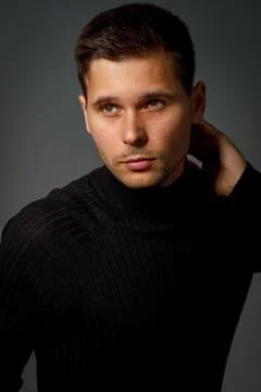 Guy in a black turtleneck on a dark background Foto stock