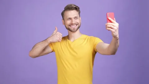 Guy blog make v sign selfie thumb up device isolated shine color background Video stock 169648014