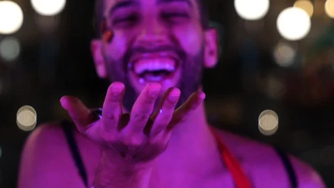 Guy blowing colorful confetti Video stock 86568098