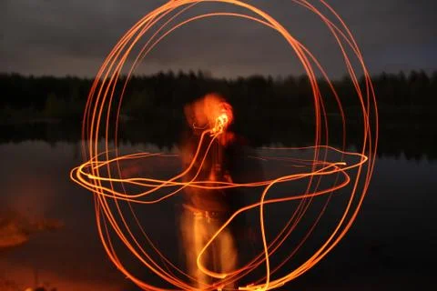 Guy blowing out rays of red and orange light 写真素材
