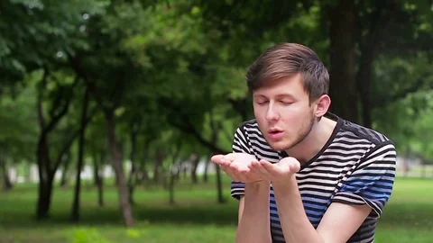 The guy blowing off the palms of the ashes Video stock 76752379