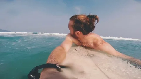 Guy with the board is waiting for the waves Stock Footage 80534387