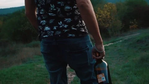 A guy with a bottle of wine in his hand Stock Footage 80517626
