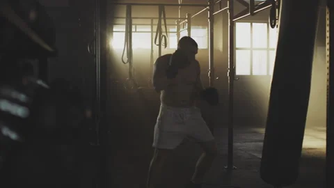 Guy boxing hard in punching bag Stock Footage 236192756