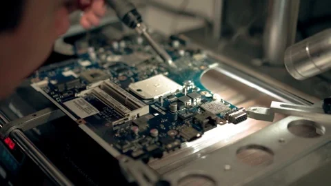 Guy brazes computer chip Stock Footage 98450793