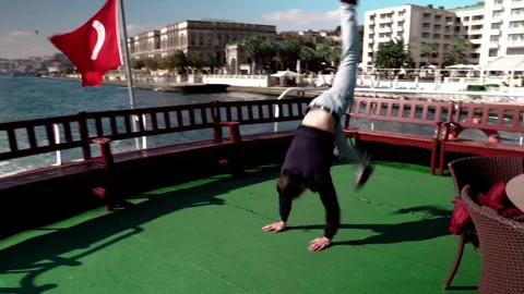 Guy breakdancing on the deck of a ship in Istanbul, Turkey Stock Footage 281641139