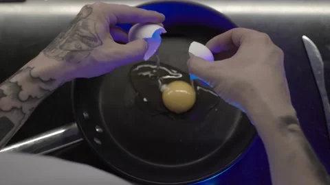 Guy breaks an egg Stock Footage 157020775