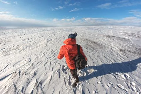 A guy with a briefcase behind his back against the background of a snow Stock Photos