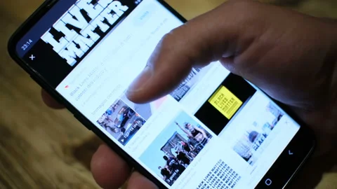 Guy browse on smartphone for support black lives matter protest in usa,no racism Stock Footage 132219673