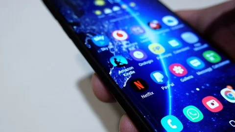 Guy browsing on a smartphone netflix app series catalog,video streaming platform Stock Footage 128211538