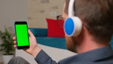 The guy browsing using his cell phone with green screen. Stock Footage 140715308