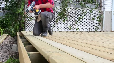 Guy builds patio Stock Footage 51730716