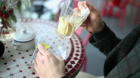The guy in the cafe drinks tea and looks out the window Stock Footage 128444492