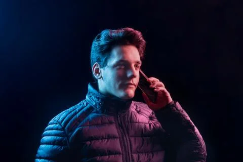 The guy is calling someone on the phone. Stock Photos