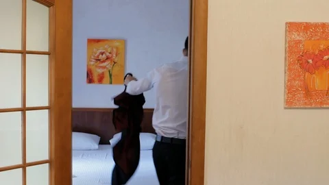 The guy came home from work and takes off his jacket, entering the room.4k video Stock Footage 111725135
