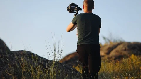 Guy with camera shoots wedding couple from different angles Stock Footage 113509133