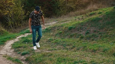 The guy in the cap goes up the hill Stock Footage 80436049