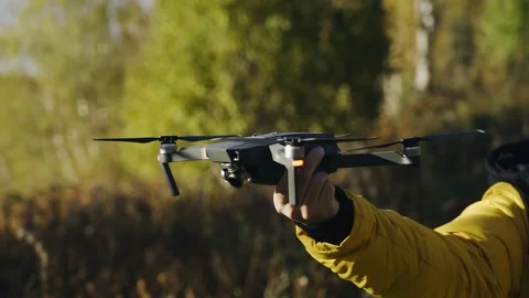 The guy catches the drone with his hand after completing the flight Stock Footage 162832121
