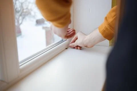 The guy catches a fly near the window Stock Photos