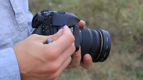 The guy changes the battery and the SD card on the camera Stock Footage 94742799