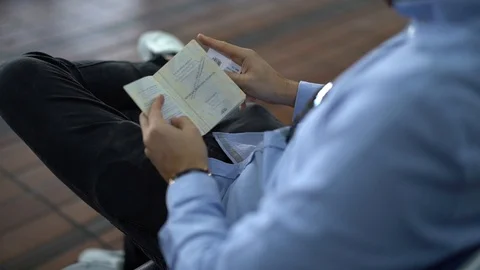 Guy checking passport on airport Stock Footage 89242574