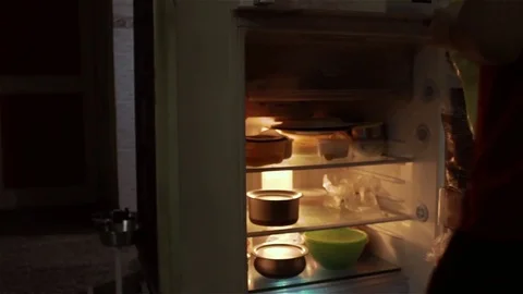 Guy Checks Out Fridge and Drinks Water From Bottle Stock Footage 76932831
