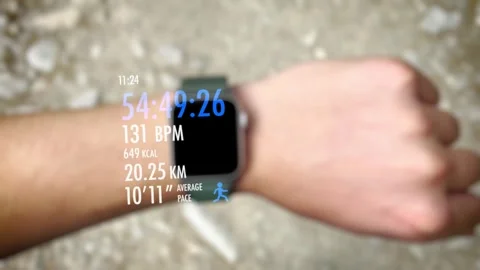 A guy checks the status of his running training on his smartwatch using an .. Stock Footage 244258099