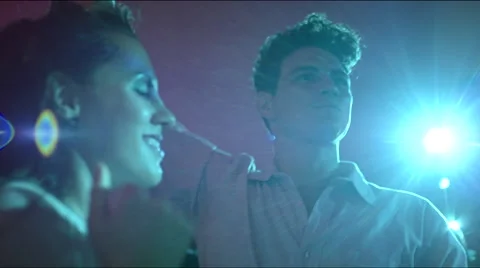 Guy cheers while girl dances seductively 스톡 동영상 63083477