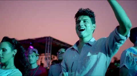 Guy cheers while girl dances seductively Stock Footage 63084319