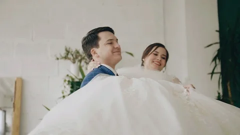 The guy is circling his beloved in his arms. Beautiful newlyweds. Good mood Stock Footage 118467649
