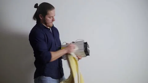 A guy cleans an ASIC for mining on a white background, jokes and smiles Stock-Footage 155055061