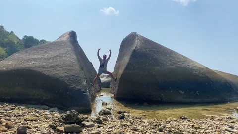 Guy climbed on a large split stone. Stock Footage 239522894
