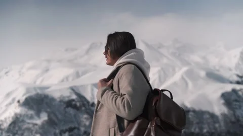 The guy climbed the peak of the mountain and enjoys the sun Stock Footage 169868431