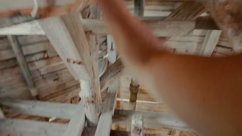 The guy climbs the ceilings of the tower at a height. From the first person. Stock Footage 314674356