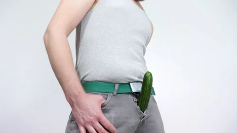 The guy climbs from his pants large cucumber. problems with potency. Stock Footage 129402647