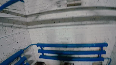 The guy climbs up on a lifting machine, hooking his hands on the hooks. Stock Footage 313953189