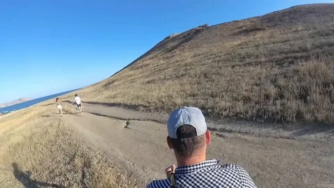 The guy climbs the mountain Stock Footage 122581066