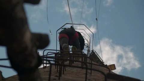 A guy climbs an old abandoned pipe , a man climbs a ladder Stock Footage 181935512