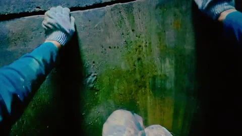 The guy climbs out of a deep well on his own without a ladder. Stock Footage 319428788