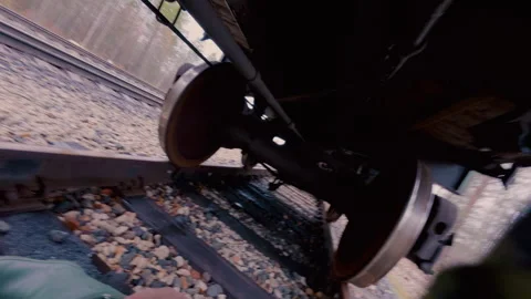 The guy climbs the rails under the transport car. From the first person. Stock Footage 320386408