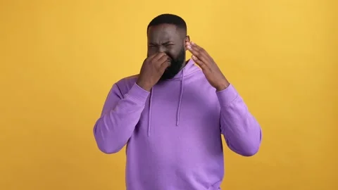 Guy close fingers nose diry stinky isolated vibrant color background 動画素材 168370642