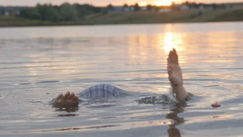  Guy in Clothes Emerges from the Water and Finds an Apple Stock Footage 87592089