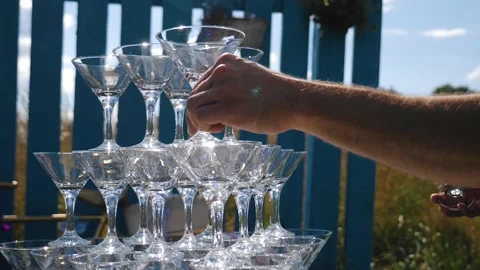 The guy collects a tower of empty glasses on the table Stock Footage 140538756