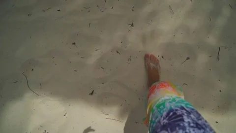 The guy in colored shorts walks on the white sand Stock Footage 72015426