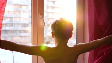 The guy comes early in the morning to the window, opens the curtains. The sun's Video stock 87216681