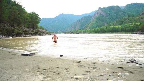 The guy comes out of the river Stock Footage 115482273