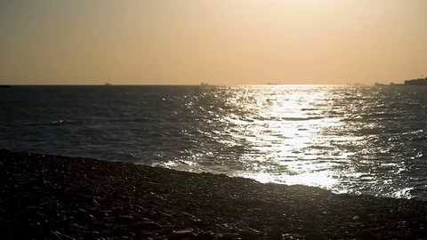 The guy comes to the water on the beach, jumps up, raises his fists up Stock Footage 113696323