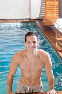 Guy coming out of the pool Stock Photos